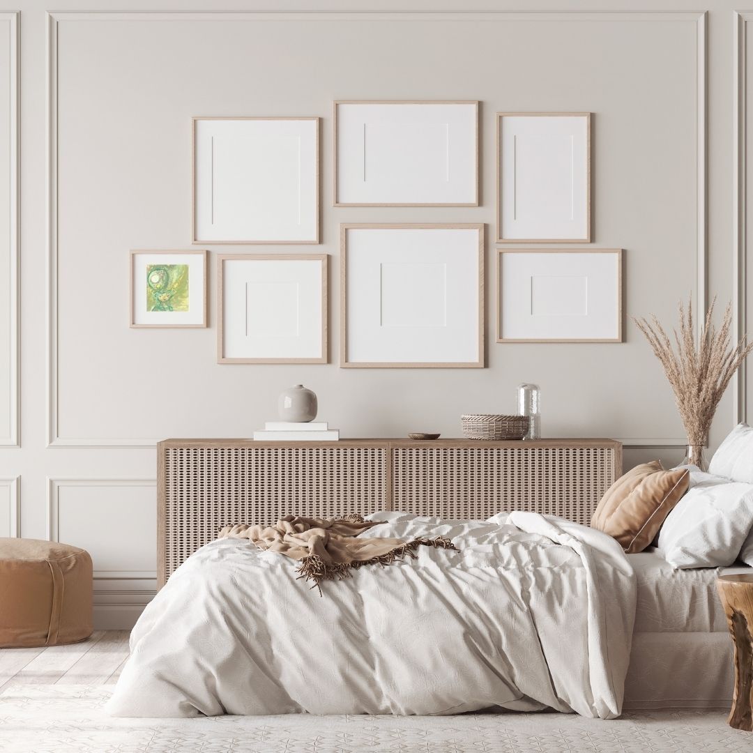 Celestial painting of a serene figure with closed eyes, framed in a square frame as part of a gallery wall in a bedroom.